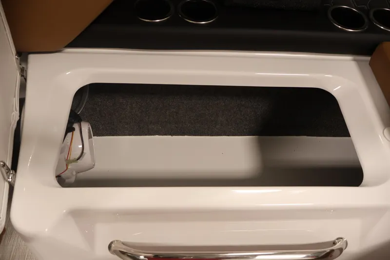 Slide: The Image of 2026 Four Winns H4 boat storage compartment with cup holders and sleek design. - 38