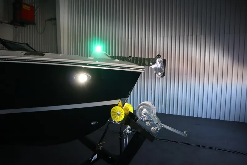Slide: The Image of 2026 Four Winns H4 boat in a dimly lit garage, showcasing its sleek design. - 61