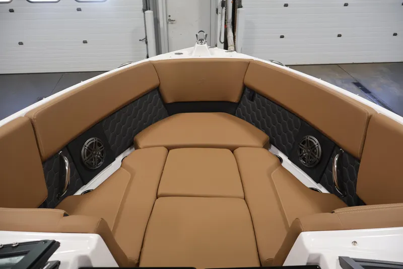 Slide: The Image of 2026 Four Winns H4 boat interior with tan seating and built-in speakers. - 10