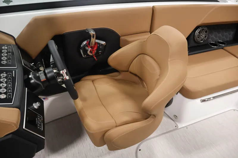 Slide: The Image of Captain's seat and controls of 2026 Four Winns H4 boat, featuring tan upholstery. - 25