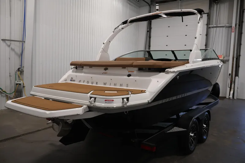 Slide: The Image of 2026 Four Winns H4 boat in a garage, showcasing sleek design and modern features. - 4