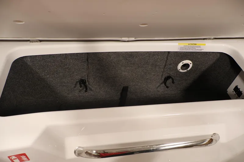 Slide: The Image of Storage compartment of 2026 Four Winns H4 boat, featuring a spacious interior and secure latch. - 35