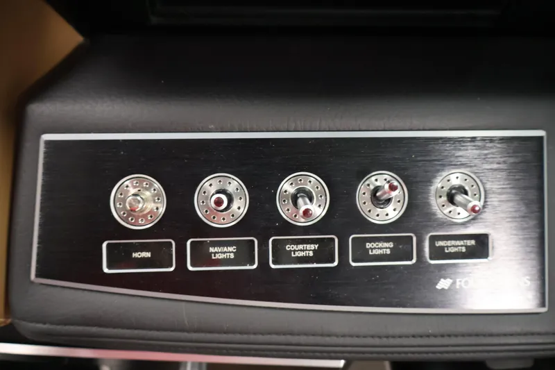 Slide: The Image of Control panel of 2026 Four Winns H4 boat with labeled switches for lights and horn. - 20