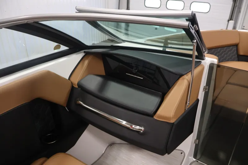 Slide: The Image of Interior of 2026 Four Winns H4 boat with tan and black seating, sleek design. - 27