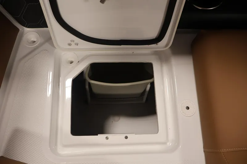 Slide: The Image of Open storage compartment on 2026 Four Winns H4 boat, featuring white and tan interior. - 34