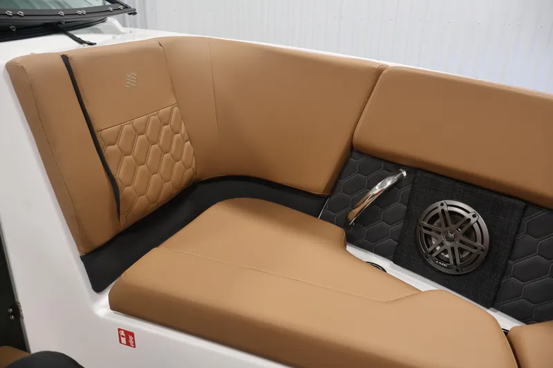 Slide: The Image of 2026 Four Winns H4 boat interior with tan leather seating and integrated speaker system. - 13