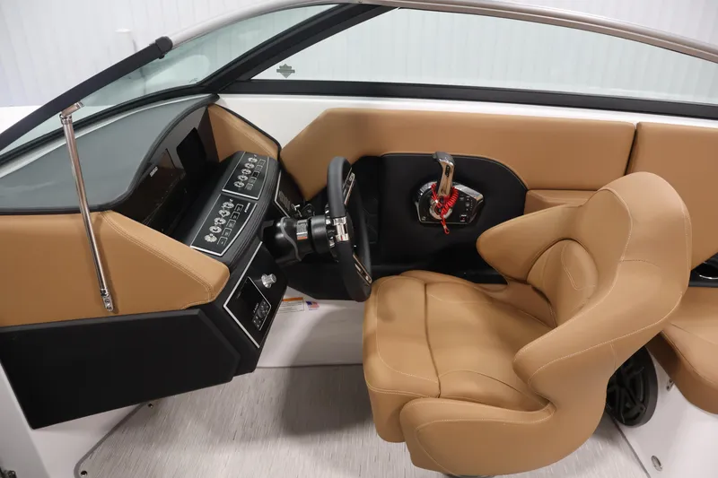 Slide: The Image of 2026 Four Winns H4 boat interior with tan leather seating and modern dashboard controls. - 16
