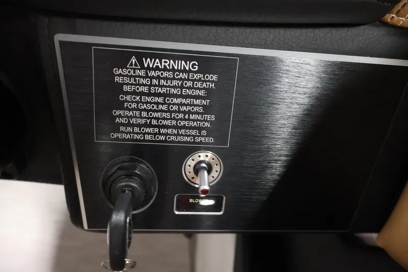 Slide: The Image of 2026 Four Winns H4 warning label and blower switch on control panel. - 23
