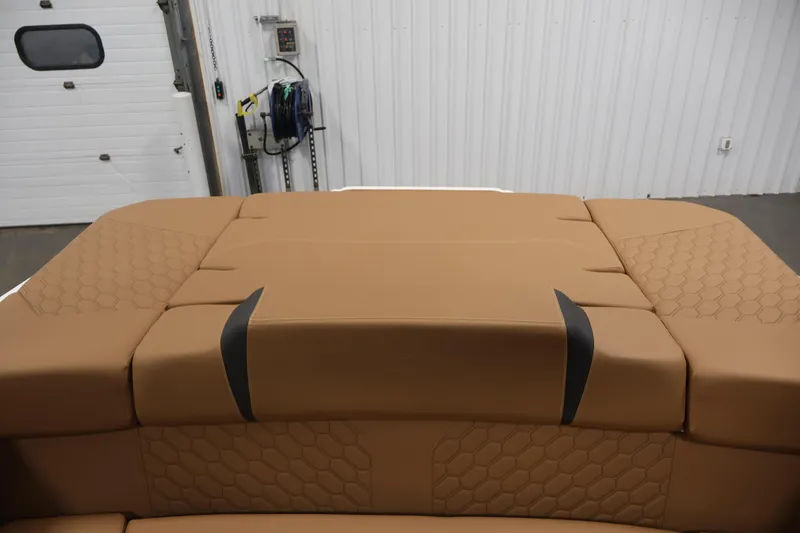 Slide: The Image of 2026 Four Winns H4 boat interior with tan upholstery and hexagonal stitching pattern. - 39