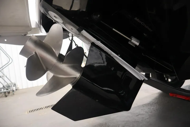 Slide: The Image of Close-up of a 2026 Four Winns H4 boat propeller in a garage setting. - 52