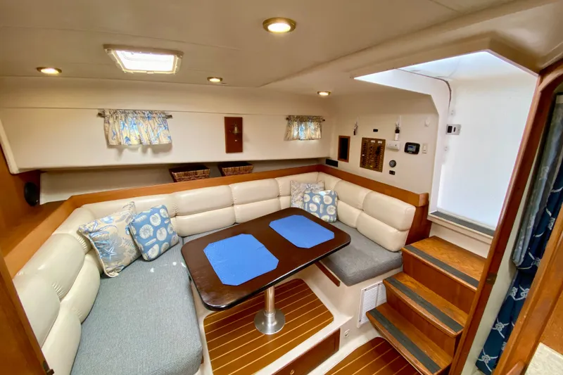 Slide: The Image of Interior of 2002 Mainship Pilot 34 boat with cozy seating and dining area. - 19