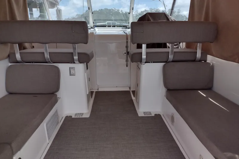 Slide: The Image of Interior of a 2002 Mainship Pilot 34 boat with cushioned seating. - 1