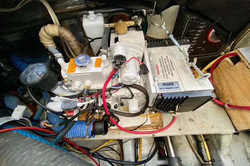 Slide: The Image of Engine compartment of a 2002 Mainship Pilot 34 boat, showcasing mechanical components and wiring. - 10