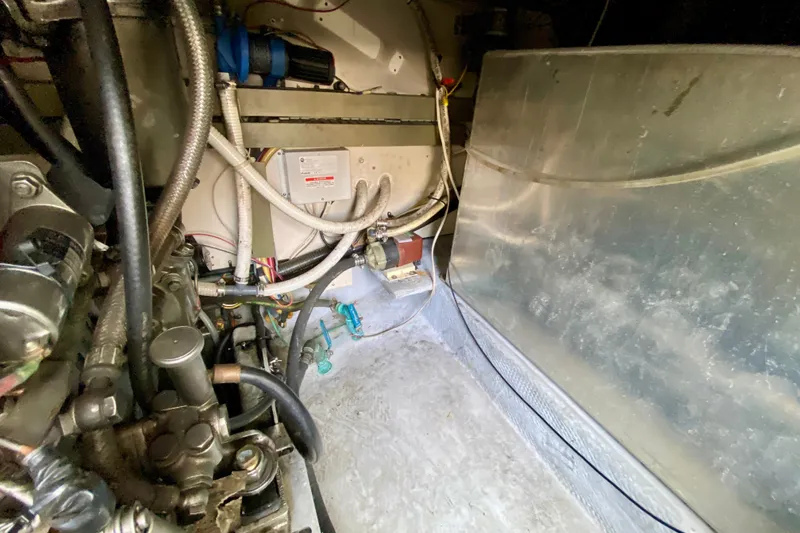 Slide: The Image of Engine room of 2002 Mainship Pilot 34 with visible wiring and components. - 55