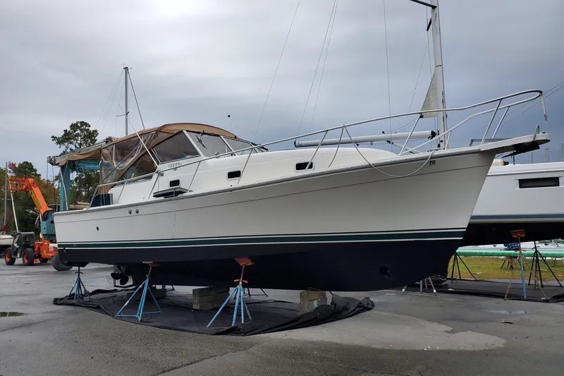 Slide: The Image of 2002 Mainship Pilot 34 boat on stands in a marina, overcast sky. - 62