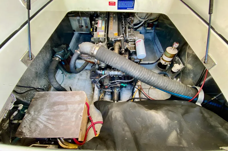 Slide: The Image of Engine compartment of a 2002 Mainship Pilot 34 boat, showcasing mechanical components. - 9