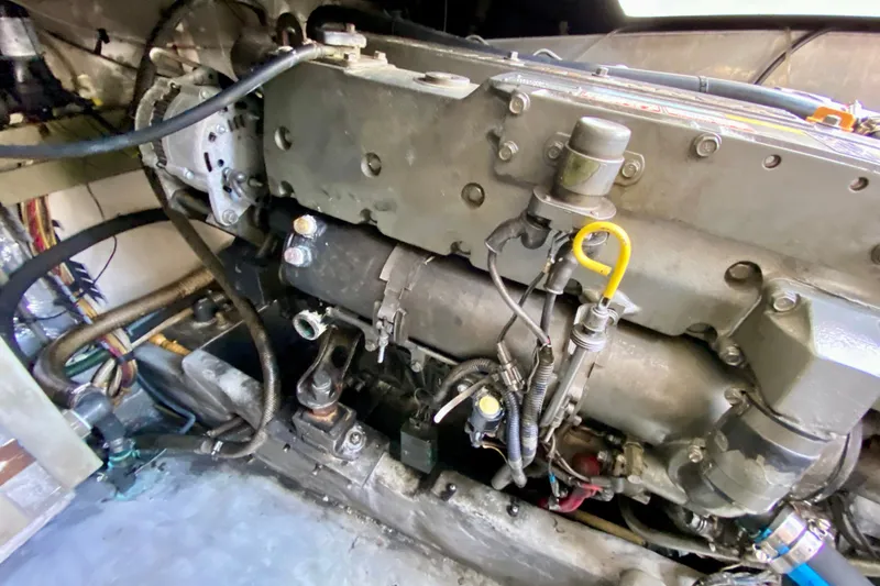 Slide: The Image of Engine compartment of a 2002 Mainship Pilot 34 boat, showcasing mechanical components and wiring. - 58