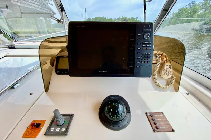 Slide: The Image of Cockpit of 2002 Mainship Pilot 34 with Garmin navigation system and compass. - 12