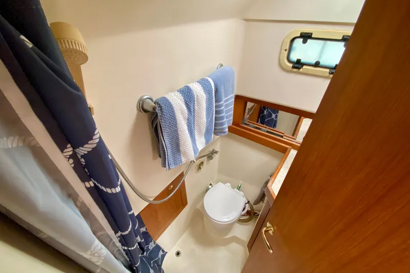 Slide: The Image of Bathroom interior of 2002 Mainship Pilot 34 boat with shower and window. - 24