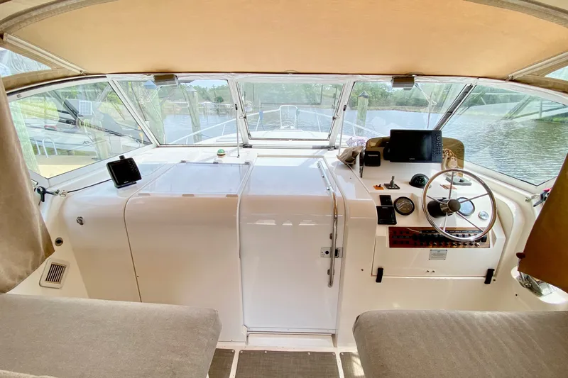 Slide: The Image of 2002 Mainship Pilot 34 boat interior with steering wheel and navigation equipment. - 15