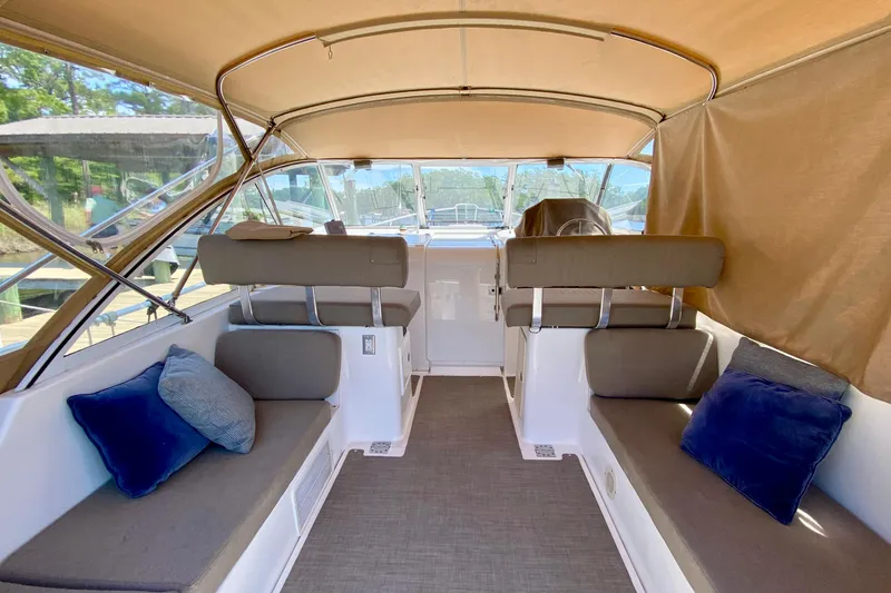 Slide: The Image of Interior of 2002 Mainship Pilot 34 boat with cushioned seating and helm. - 1