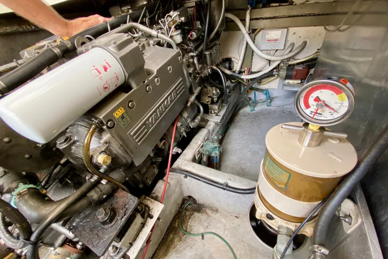 Slide: The Image of Engine room of a 2002 Mainship Pilot 34, showcasing mechanical components and gauges. - 53