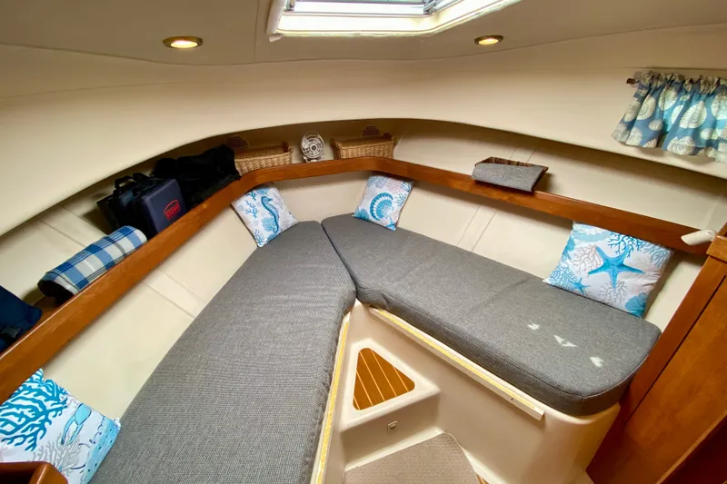Slide: The Image of 2002 Mainship Pilot 34 cabin interior with cozy seating and nautical decor. - 32