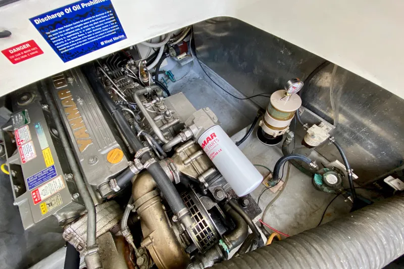 Slide: The Image of Engine compartment of a 2002 Mainship Pilot 34 with Yanmar diesel engine components. - 56