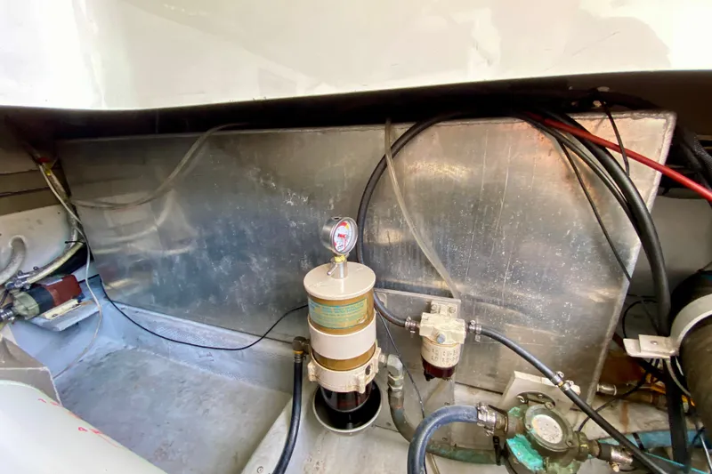 Slide: The Image of Engine compartment of a 2002 Mainship Pilot 34 boat, showing fuel filters and wiring. - 61
