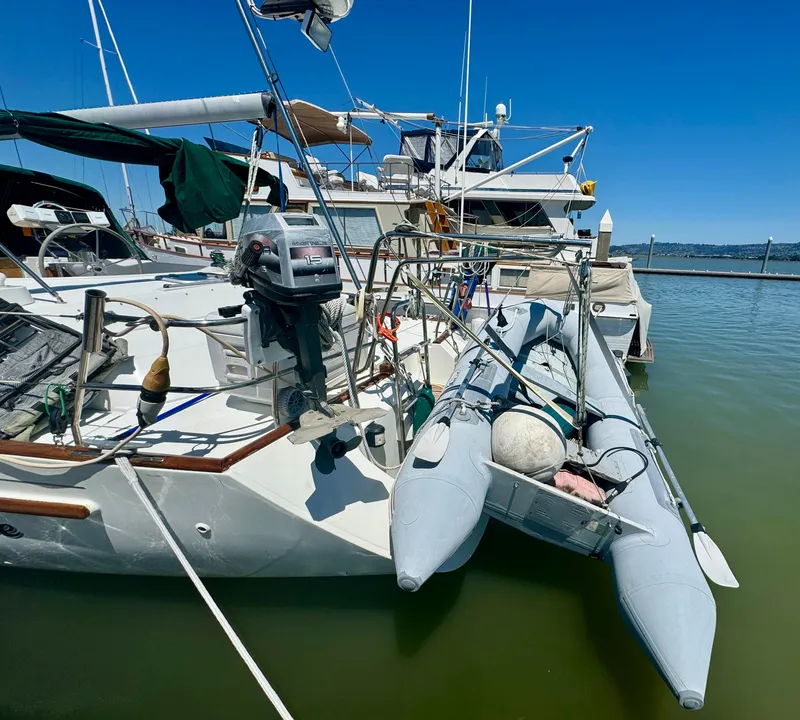 Slide: The Image of 1996 Beneteau Oceanis 40 CC sailboat docked with inflatable dinghy attached. - 28
