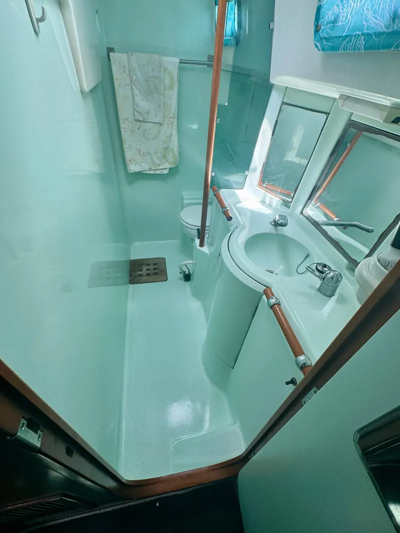 Slide: The Image of Bathroom interior of 1996 Beneteau Oceanis 40 CC yacht, featuring sink and shower. - 19