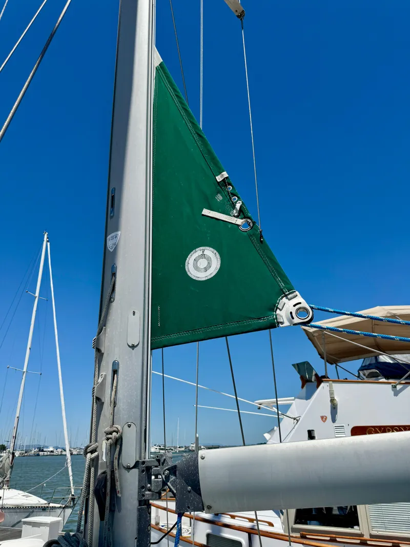 Slide: The Image of Sailboat mast and sail detail on 1996 Beneteau Oceanis 40 CC under clear blue sky. - 22