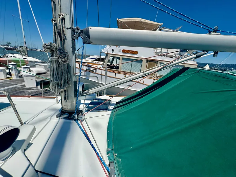 Slide: The Image of Beneteau Oceanis 40 CC sailboat deck, 1996 model, docked at marina under clear blue sky. - 25