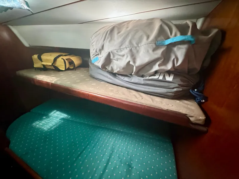 Slide: The Image of Beneteau Oceanis 40 CC 1996 cabin with storage bags on a wooden shelf. - 8