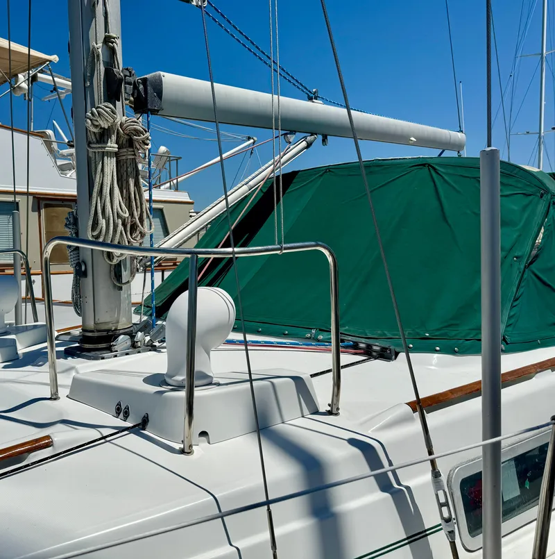 Slide: The Image of 1996 Beneteau Oceanis 40 CC sailboat deck with green cover and rigging. - 23