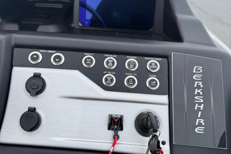 Slide: The Image of Control panel of 2027 Berkshire 25RFX STS boat with various switches and controls. - 15