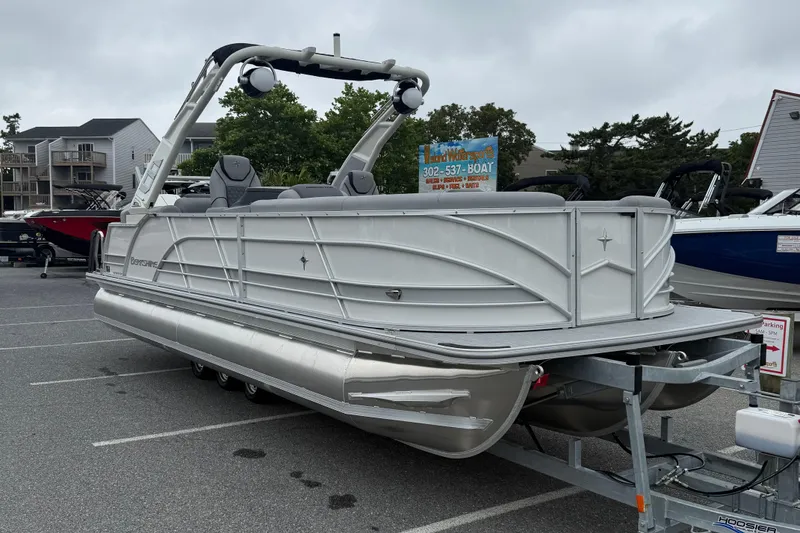 Slide: The Image of 2027 Berkshire 25RFX STS pontoon boat on trailer in parking lot. - 2
