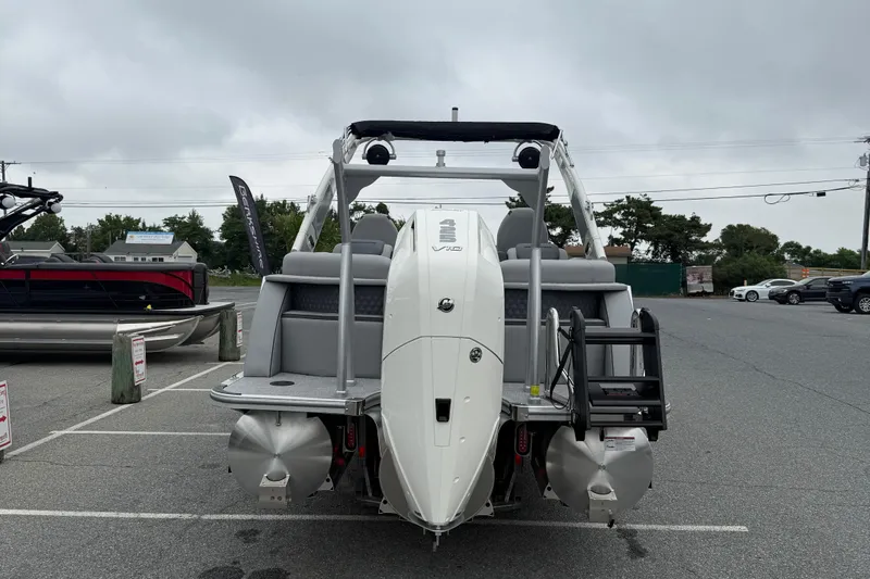 Slide: The Image of 2027 Berkshire 25RFX STS pontoon boat with powerful outboard motor in a parking lot. - 7