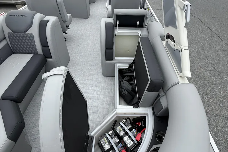 Slide: The Image of 2027 Berkshire 25RFX STS boat interior with open storage compartments and seating. - 16