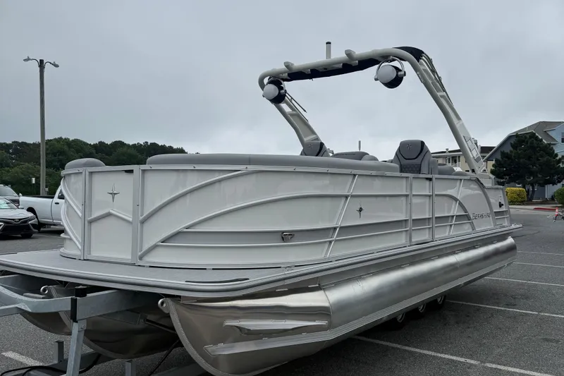 Slide: The Image of 2027 Berkshire 25RFX STS pontoon boat parked in a lot, showcasing sleek design and modern features. - 4