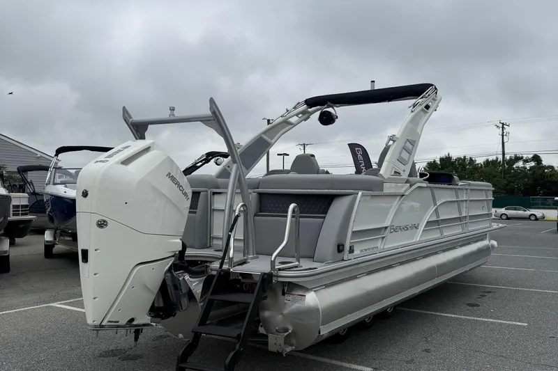 Slide: The Image of 2027 Berkshire 25RFX STS pontoon boat with Mercury outboard engine in a parking lot. - 8