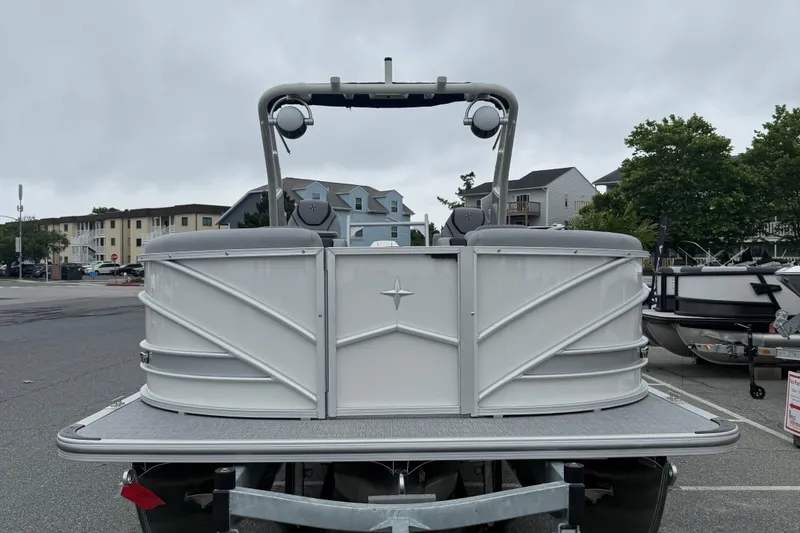 Slide: The Image of 2027 Berkshire 25RFX STS pontoon boat parked in a marina with overcast skies. - 3