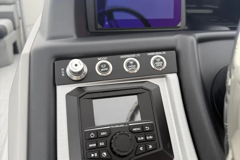 Slide: The Image of Control panel of 2027 Berkshire 25RFX STS boat with lighting and audio controls. - 14