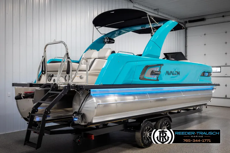 Slide: The Image of 2025 Avalon 2585 Excal VRBW pontoon boat in a showroom with blue accents. - 6