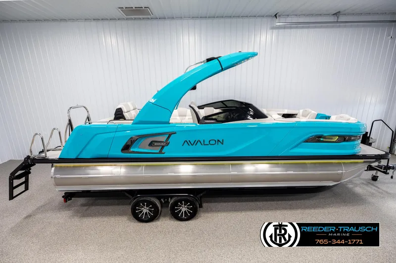 The Image of 2025 Avalon 2585 Excal VRBW pontoon boat in a showroom, vibrant blue color. - 0
