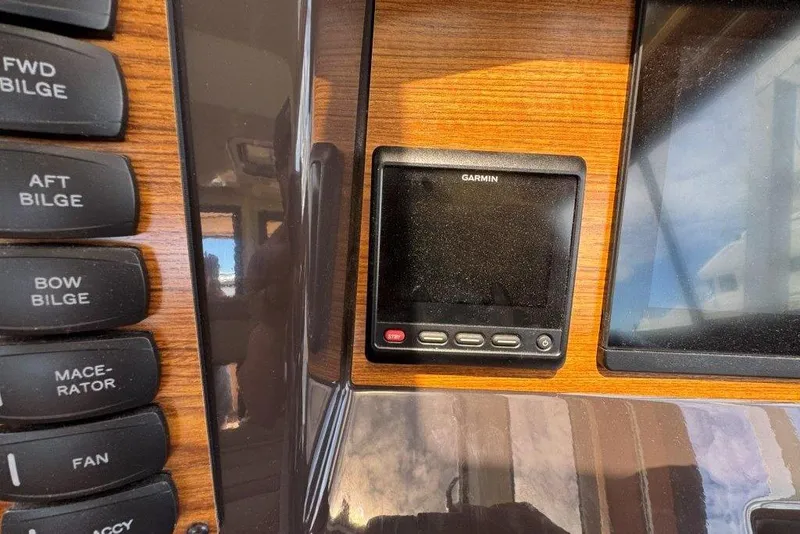 Slide: The Image of Control panel of 2022 Ranger Tugs R-27 with Garmin display and bilge switches. - 20