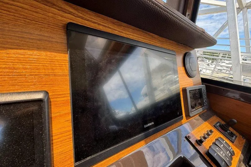 Slide: The Image of Dashboard of 2022 Ranger Tugs R-27 with Garmin display and controls. - 19