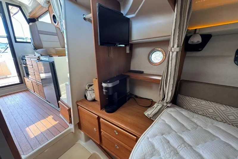 Slide: The Image of Interior of 2022 Ranger Tugs R-27 boat with cozy cabin and kitchenette. - 25