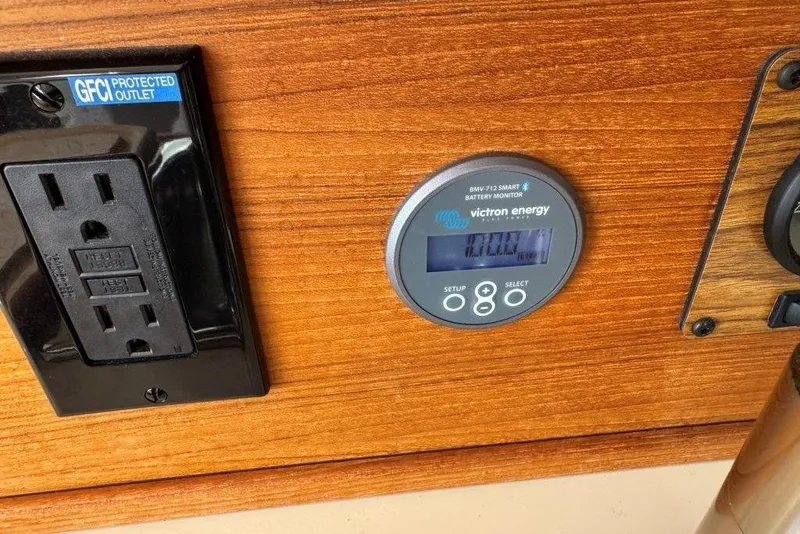 Slide: The Image of GFCI outlet and Victron Energy battery monitor on 2022 Ranger Tugs R-27 boat. - 10
