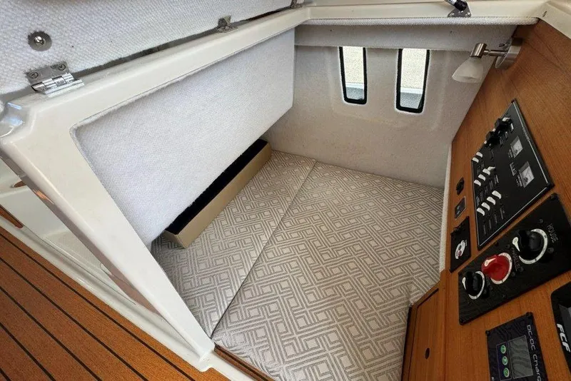 Slide: The Image of 2022 Ranger Tugs R-27 cabin interior with control panel and patterned flooring. - 30